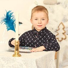 Мальчик подписывает новогоднюю открытку