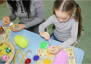 Дівчинка займається рукоділлям